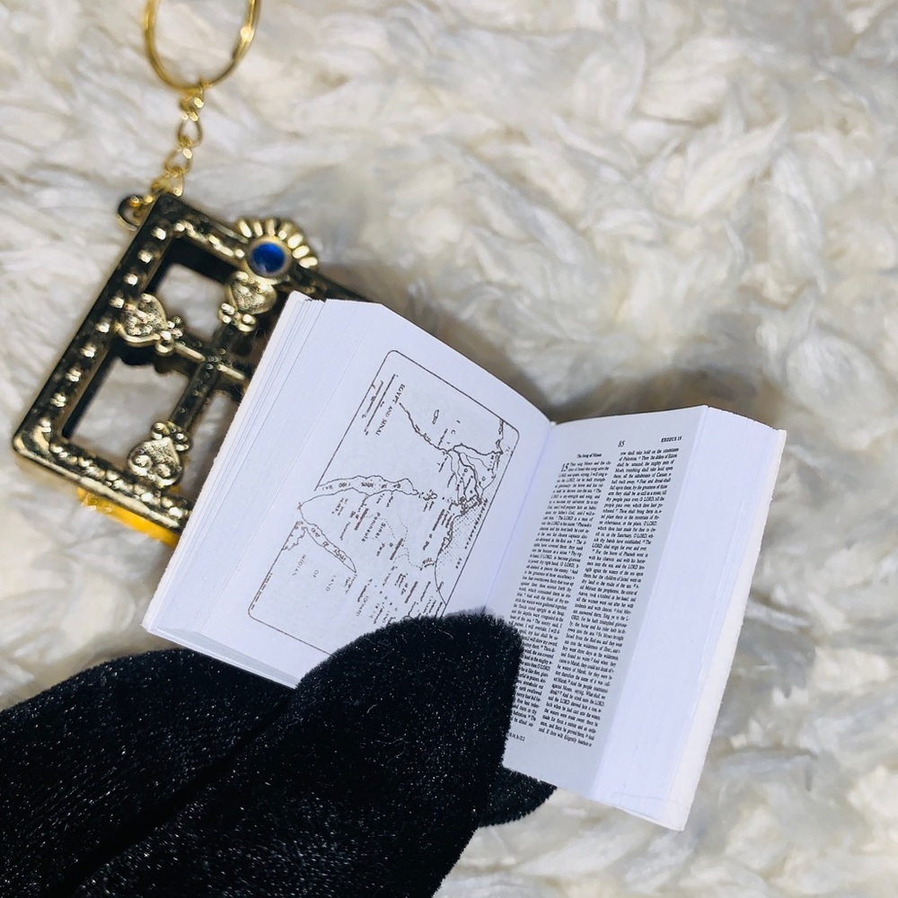 New portable Bible keychain with real pages and scriptures in gold tone case